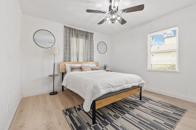 bedroom with ceiling fan and light hardwood / wood-style floors