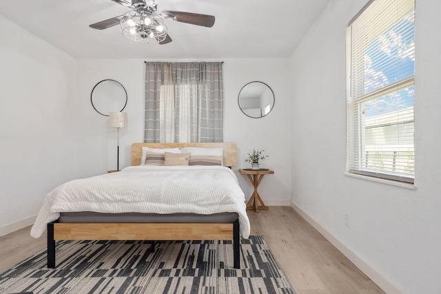 bedroom with hardwood / wood-style flooring and ceiling fan