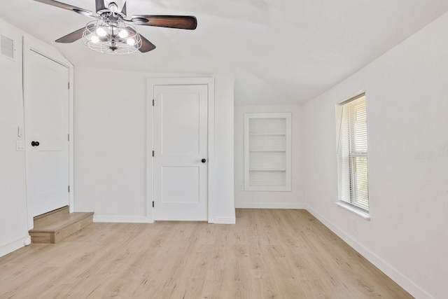 unfurnished bedroom with ceiling fan, light hardwood / wood-style flooring, and vaulted ceiling