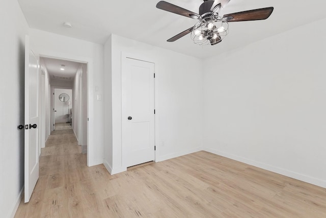 spare room featuring light hardwood / wood-style flooring and ceiling fan