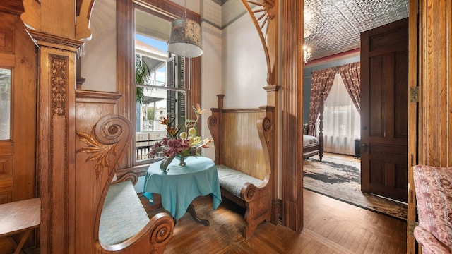 living area featuring brick ceiling, wood walls, and parquet floors