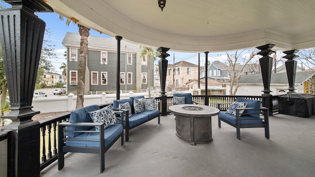 view of patio / terrace with grilling area and an outdoor living space with a fire pit