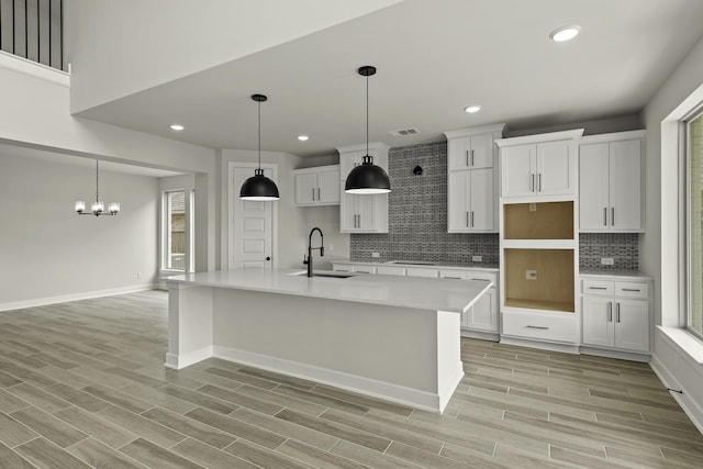 10807 Lighthouse Peak Trce, Richmond, TX 77406 - kitchen featuring a sink, white cabinetry, a center island with sink, tasteful backsplash, and recessed lighting
