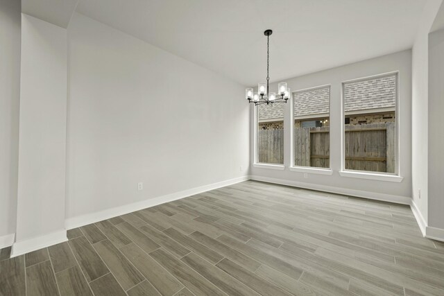 10807 Lighthouse Peak Trce, Richmond, TX 77406 - unfurnished dining area featuring a chandelier, wood finished floors, and baseboards