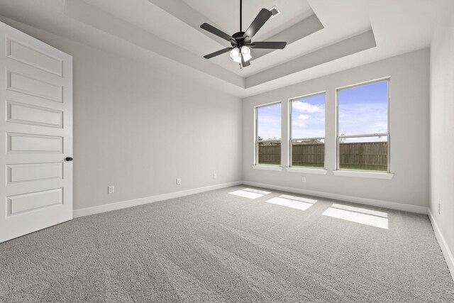 10807 Lighthouse Peak Trce, Richmond, TX 77406 - empty room with a tray ceiling, carpet floors, baseboards, and ceiling fan