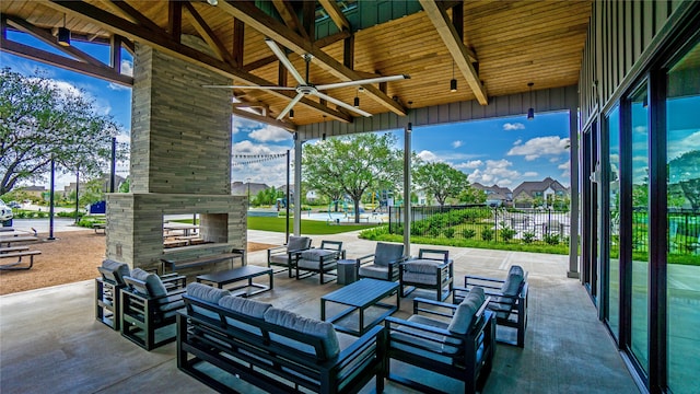 10807 Lighthouse Peak Trce, Richmond, TX 77406 - view of patio featuring a ceiling fan and an outdoor living space with a fireplace