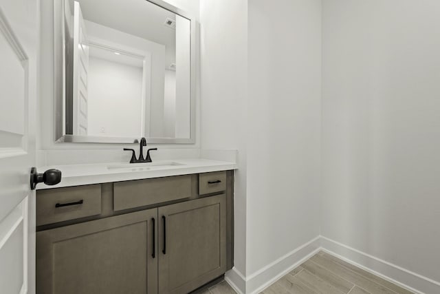 26515 Castra Crescent Trl, Richmond, TX 77406 - bathroom featuring baseboards, vanity, and wood finished floors