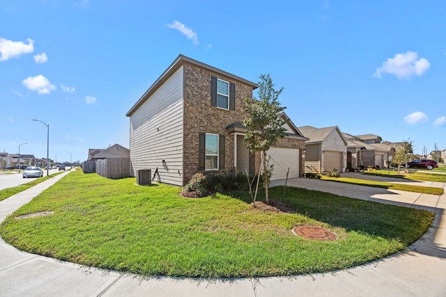 view of side of property featuring a garage, central AC unit, and a yard