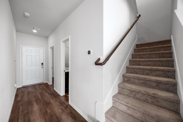 stairway with hardwood / wood-style flooring