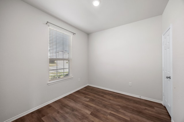 empty room with dark hardwood / wood-style floors