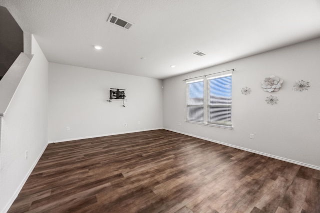 unfurnished room with dark hardwood / wood-style flooring