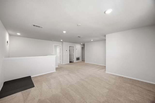 spare room featuring light colored carpet