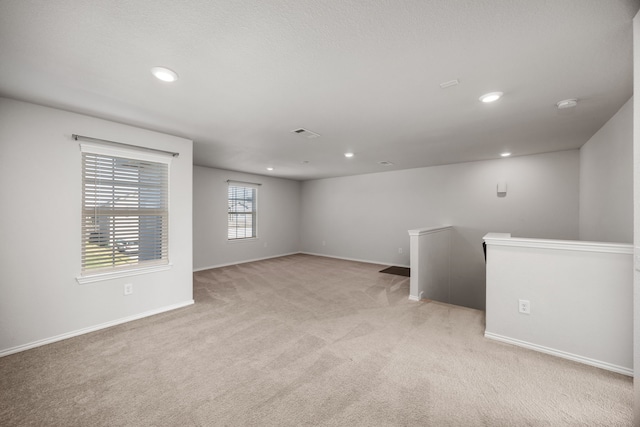 unfurnished room with light colored carpet