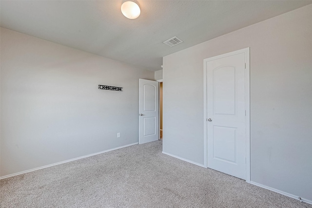 unfurnished bedroom with a closet and carpet