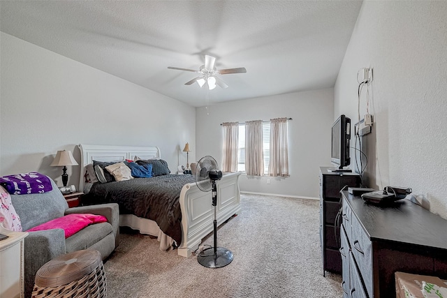 carpeted bedroom featuring ceiling fan and a textured ceiling