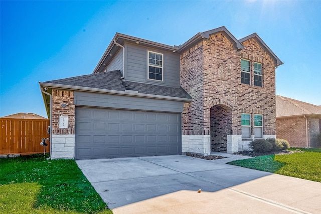 view of property featuring a front lawn and a garage