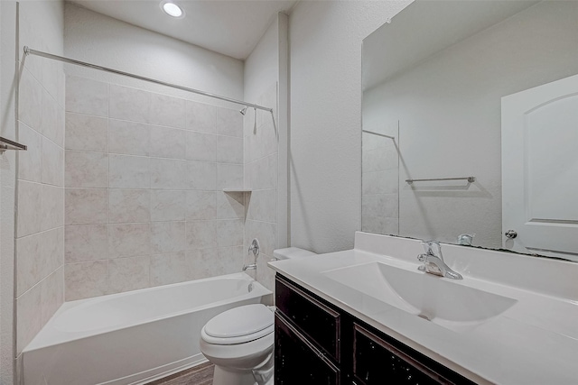 full bathroom with wood-type flooring, toilet, vanity, and tiled shower / bath