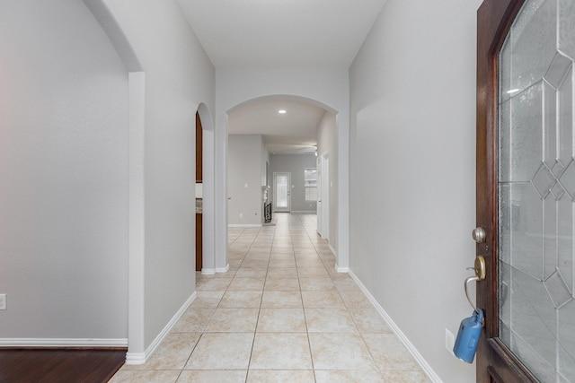 hall featuring light tile patterned floors