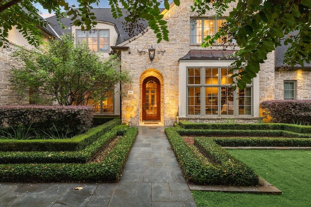 doorway to property featuring a lawn