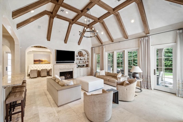 living room with built in features, high vaulted ceiling, beamed ceiling, and a fireplace