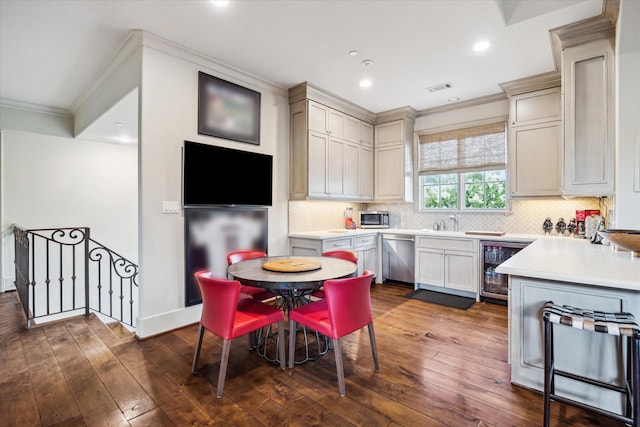 kitchen with crown molding, backsplash, stainless steel dishwasher, and dark hardwood / wood-style flooring