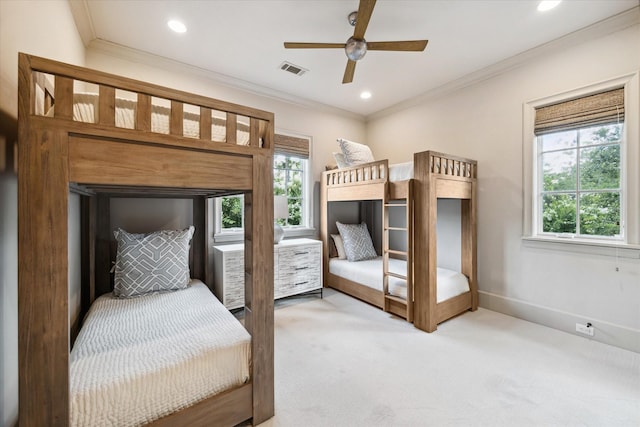 carpeted bedroom featuring ceiling fan and ornamental molding