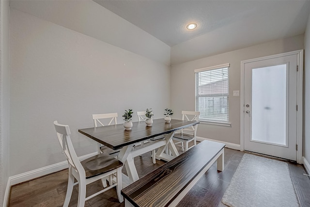 dining space featuring hardwood / wood-style flooring and lofted ceiling