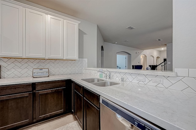 kitchen featuring dishwasher, white cabinetry, sink, backsplash, and light tile patterned floors