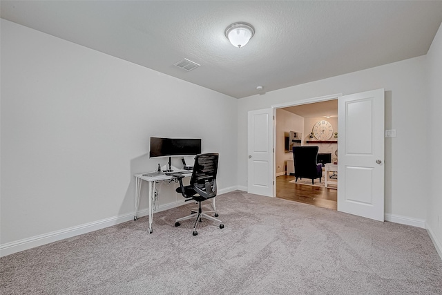 office area featuring carpet and a textured ceiling