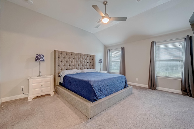 carpeted bedroom with multiple windows, vaulted ceiling, and ceiling fan