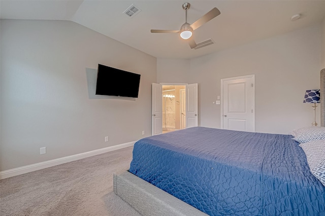 bedroom with ceiling fan, vaulted ceiling, and carpet floors