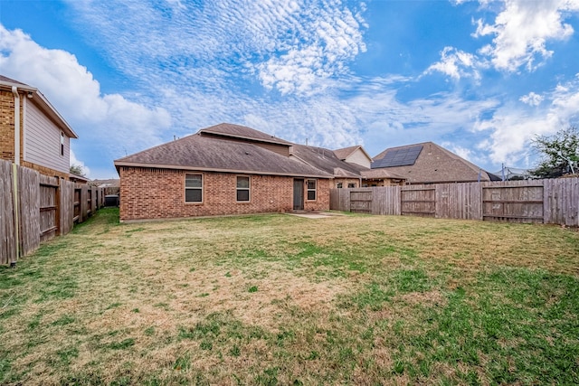 rear view of property with a yard