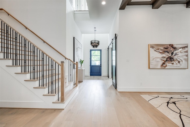 2231 Colquitt St, Houston, TX 77098 - entryway with wood finished floors, stairs, a high ceiling, a chandelier, and baseboards