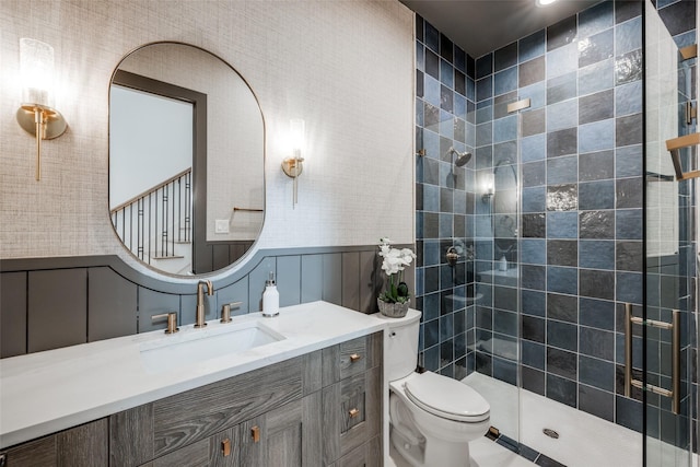2231 Colquitt St, Houston, TX 77098 - bathroom with a tile shower, toilet, vanity, a decorative wall, and a wainscoted wall