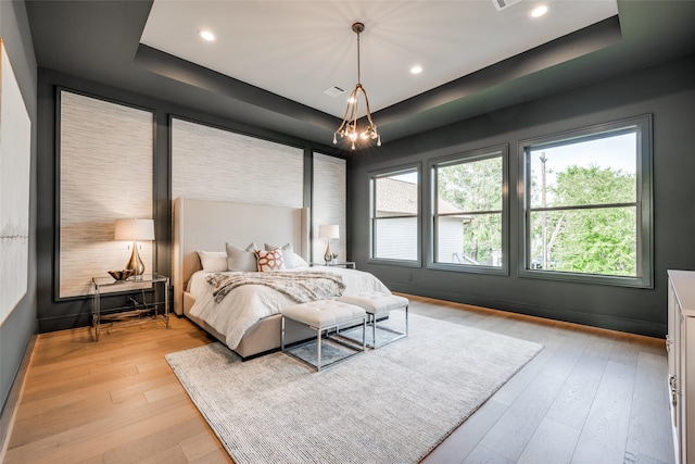 2231 Colquitt St, Houston, TX 77098 - bedroom with a tray ceiling, light wood-type flooring, a chandelier, and recessed lighting