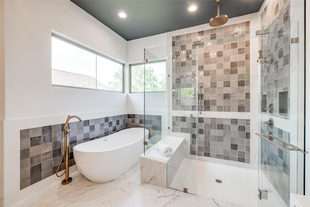2231 Colquitt St, Houston, TX 77098 - full bath with a soaking tub, a shower stall, recessed lighting, tile walls, and marble finish floors