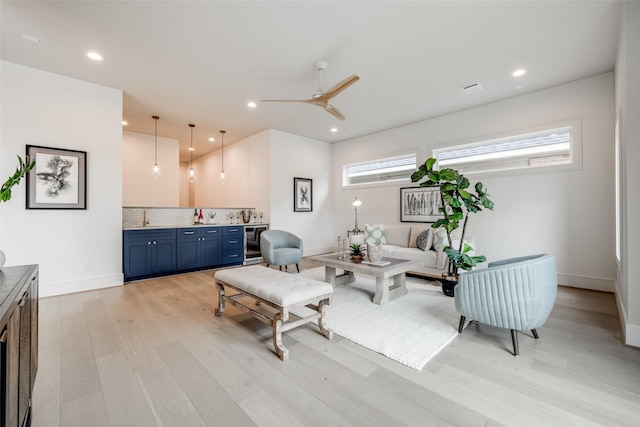 2231 Colquitt St, Houston, TX 77098 - living room featuring wet bar, light wood-type flooring, beverage cooler, baseboards, and recessed lighting