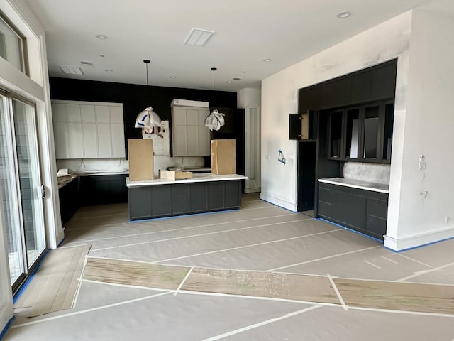 2231 Colquitt St, Houston, TX 77098 - kitchen with a kitchen island, light countertops, pendant lighting, and baseboards