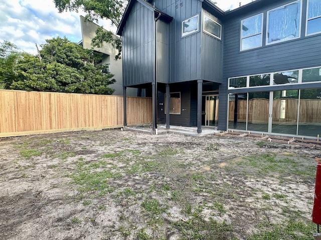 2231 Colquitt St, Houston, TX 77098 - rear view of house with fence and board and batten siding