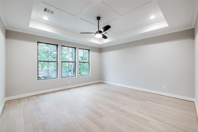 spare room featuring light wood-type flooring, ceiling fan, and crown molding