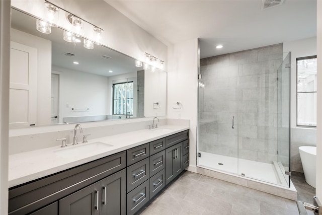 bathroom with plus walk in shower, tile patterned flooring, and vanity