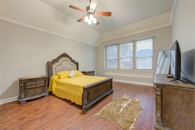 bedroom featuring dark wood-type flooring, vaulted ceiling, and ceiling fan