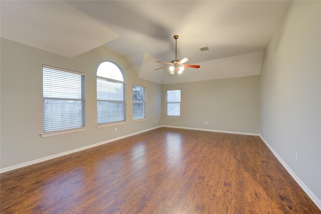 empty room with ceiling fan, dark hardwood / wood-style floors, and lofted ceiling