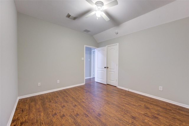 empty room with ceiling fan, dark wood-type flooring, and lofted ceiling