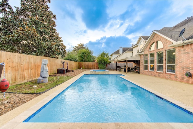 view of pool featuring an in ground hot tub, a patio, and an outdoor bar