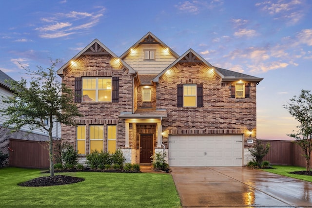 craftsman inspired home with a garage and a yard