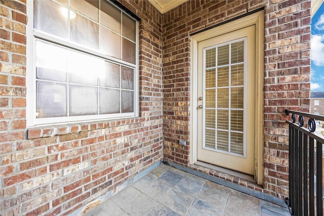 view of exterior entry featuring a balcony