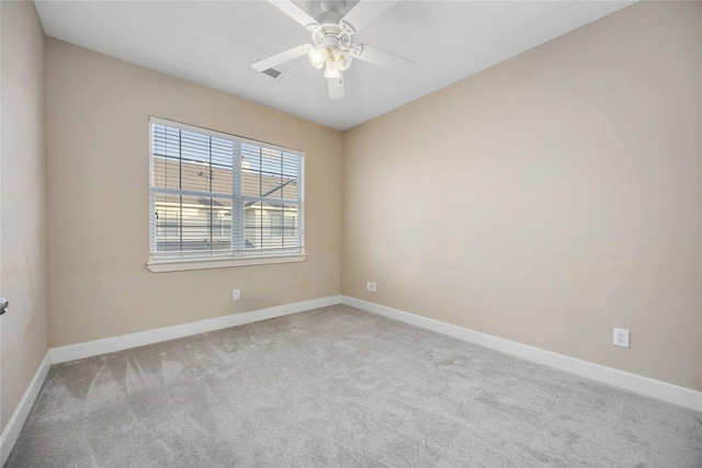 carpeted spare room with ceiling fan