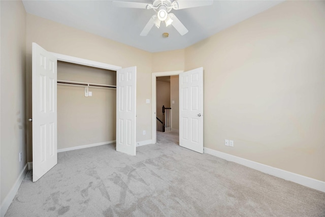 unfurnished bedroom with light carpet, a closet, and ceiling fan