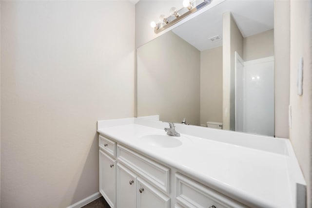 bathroom featuring vanity and toilet